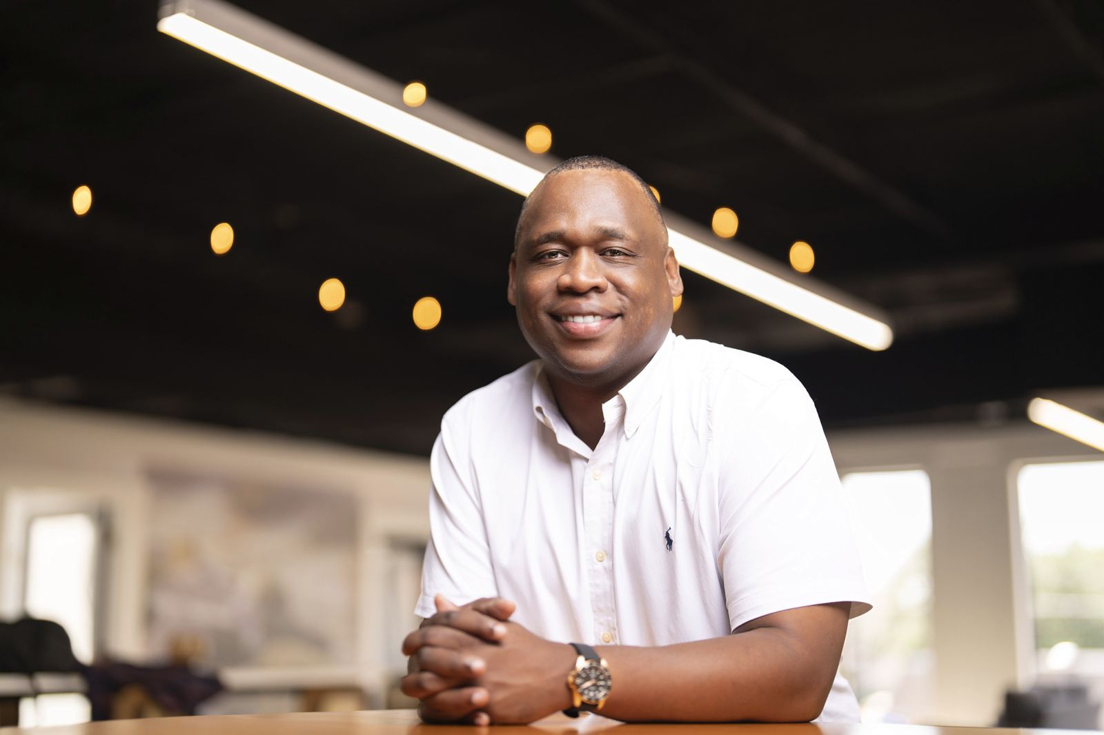 Antwann Richardson leaning on a table in a bright office