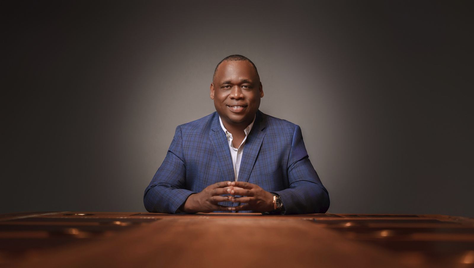 Antwann Richardson seated at a wooden conference table